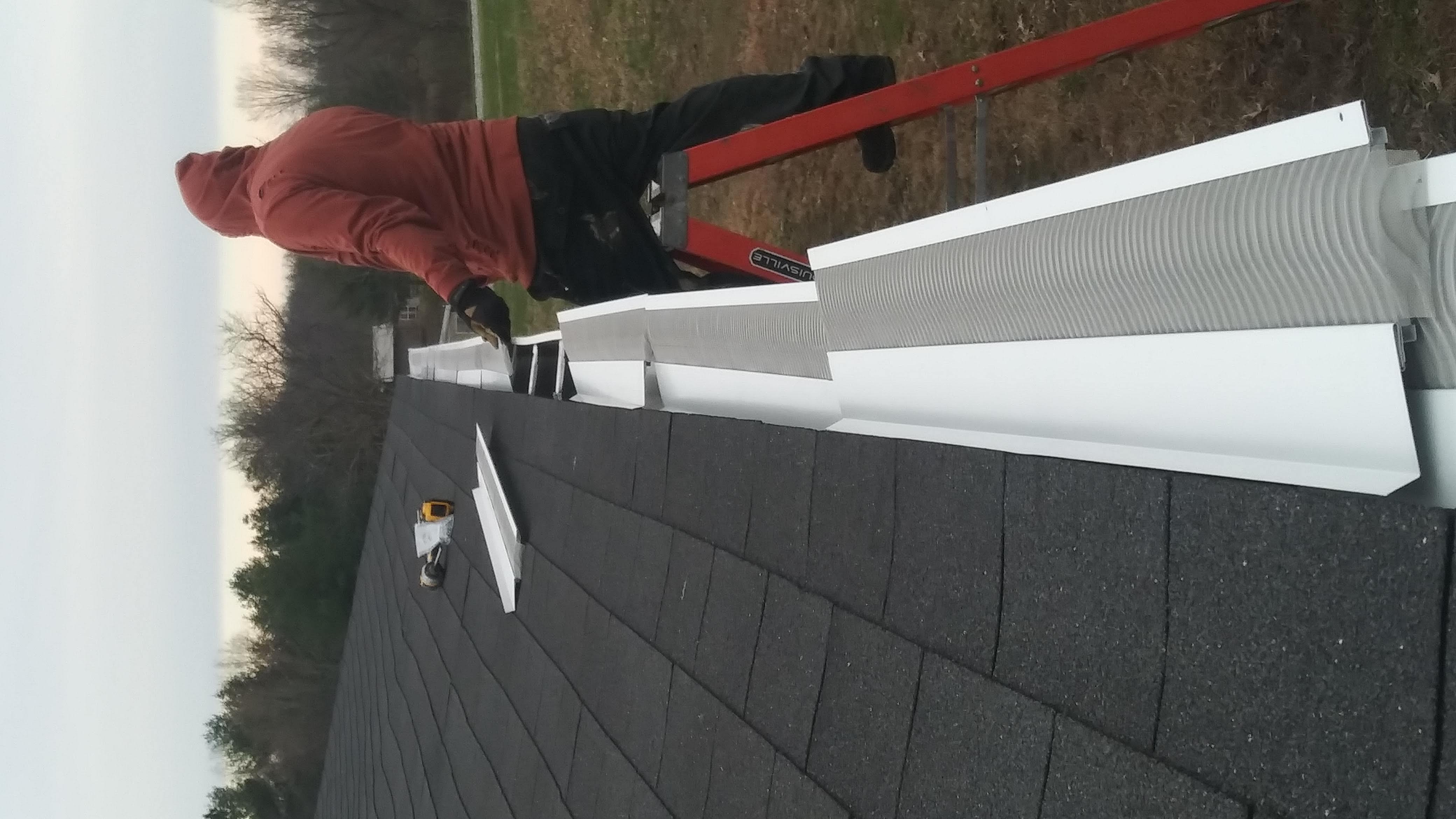 Professional installer securing a premium gutter guard system onto seamless gutters.