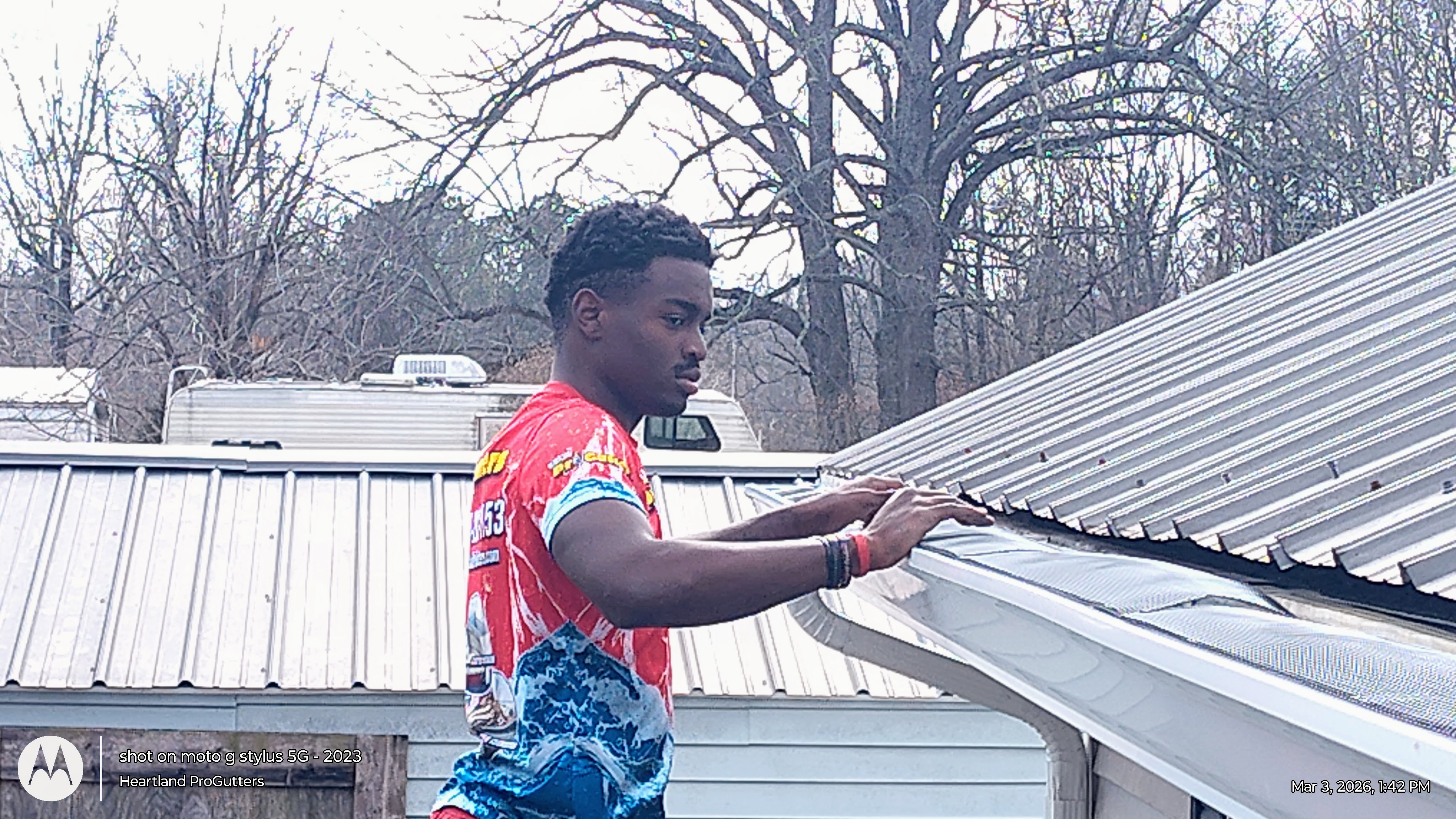 Gutter guard being checked on an existing residential gutter