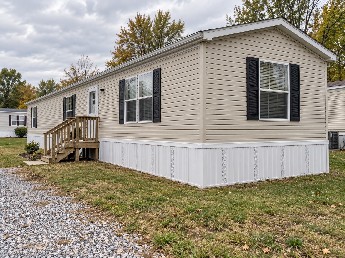 Illustrative single-wide home with new white vented basic vinyl skirting