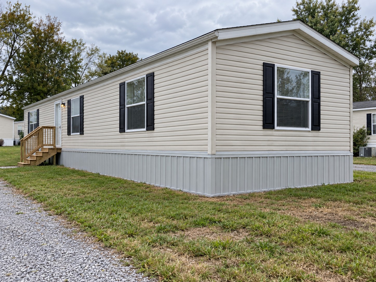 Illustrative single-wide home with clean light gray ribbed metal skirting