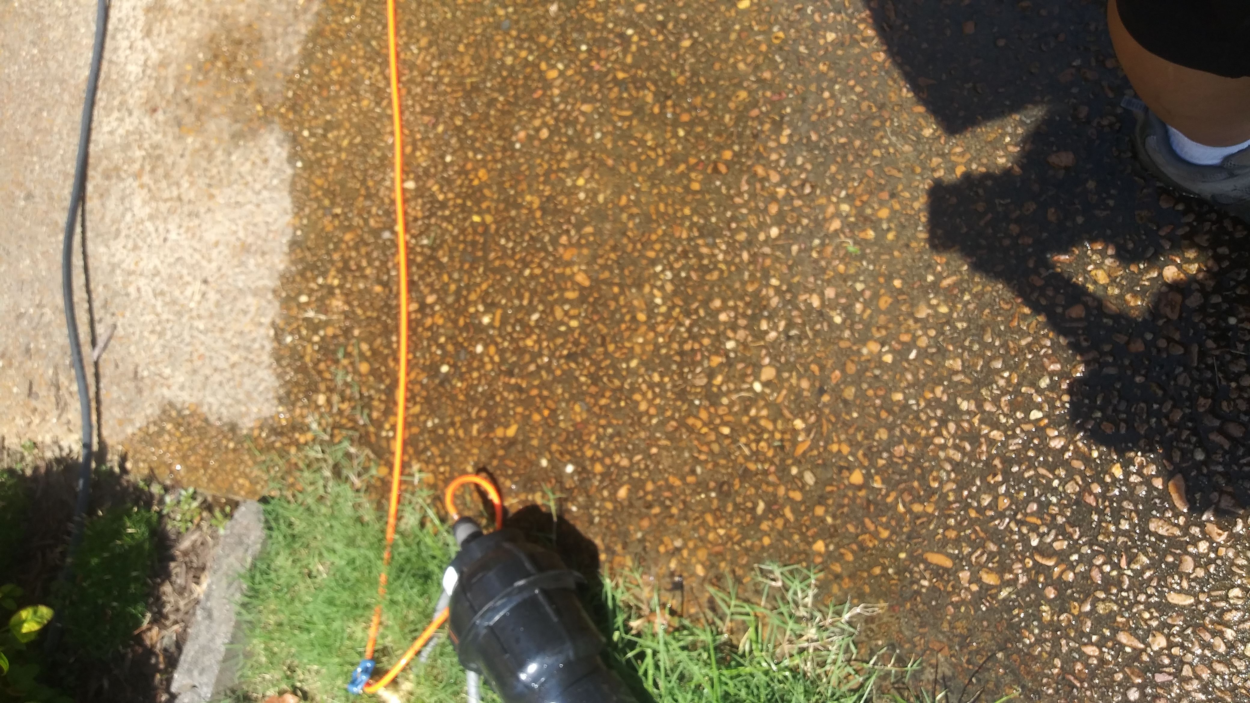 Window cleaning water supply and hose setup at a Heartland ProGutters project
